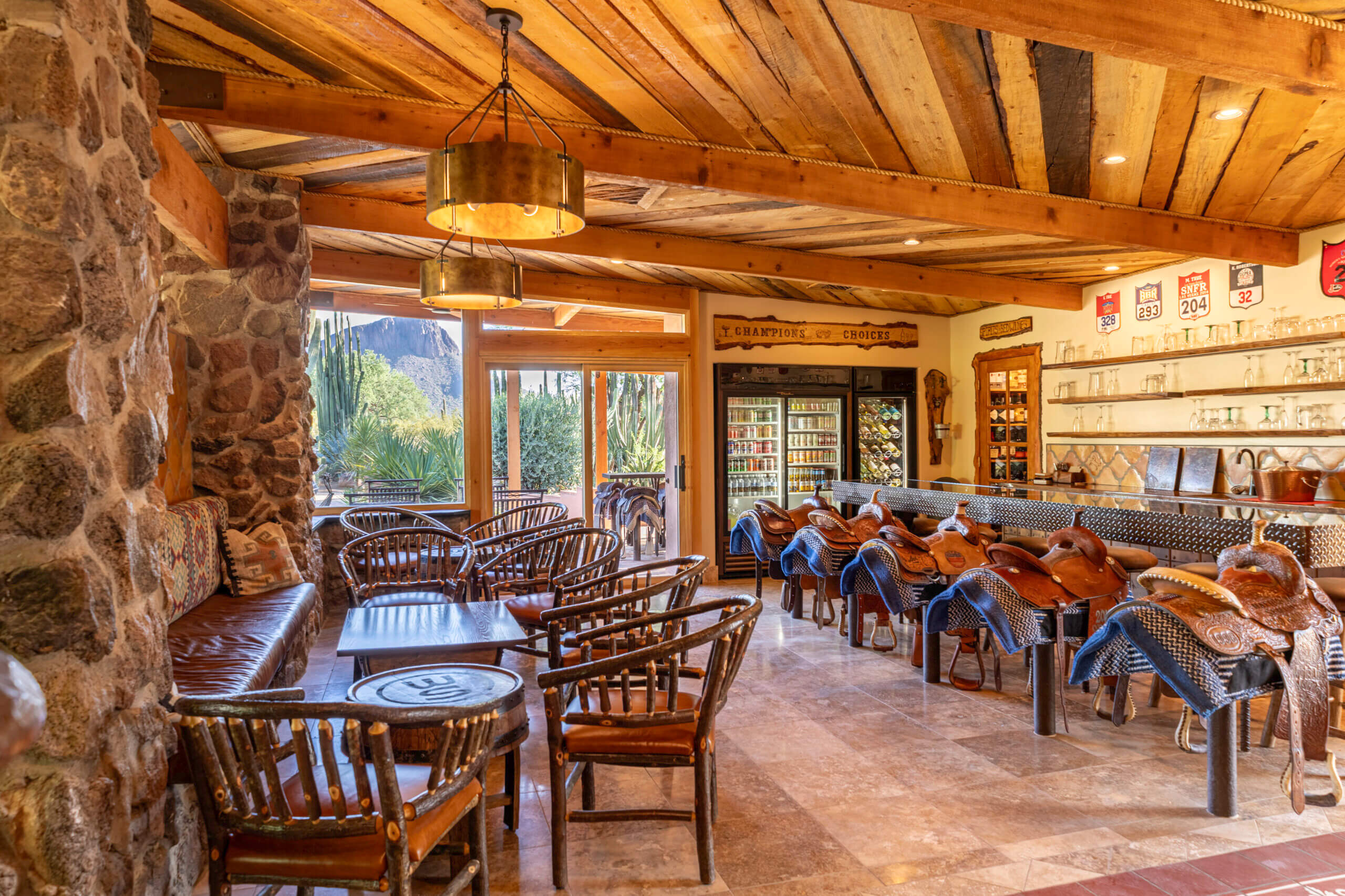 The Chappions Saloon, with seating area, Saddle stools and the mountains out side the main lodge